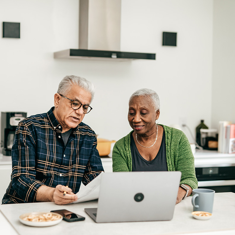 Retirees ReviewingPaperwork Kitchen 792x792